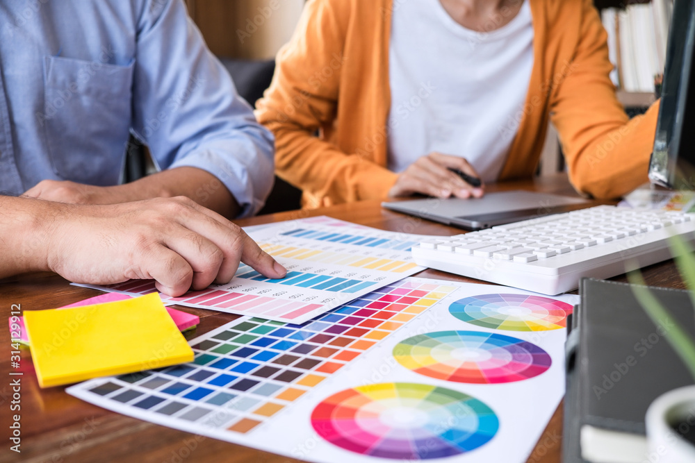 Aufkleber Two colleagues creative graphic designer working on color selection and drawing on graphics tablet at workplace