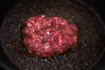Delicious burger preparation in grill pan