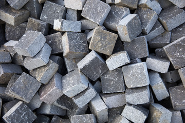Heap of stone blocks prepared for paving the street