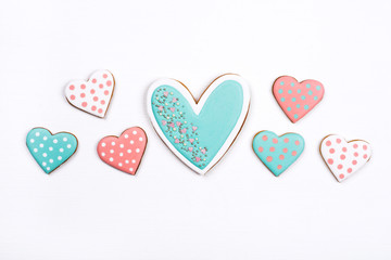 Gingerbread cookies with frosting in the shape of a heart on white background. Valentines day concept. Flat lay, top view. - Powered by Adobe