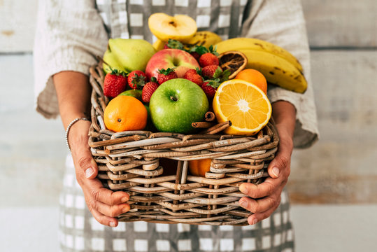 Close up of bucket full of fresh seasonal coloured fruits for healthy lifestyle and diet nutrition plan - local market shop kilometers zero near home suport concept