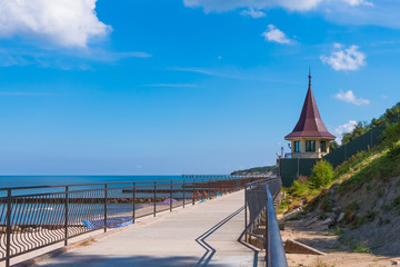 A boardwalk along the beach along the Baltic Sea in sunny summer day. City Pionersky, Kaliningrad region