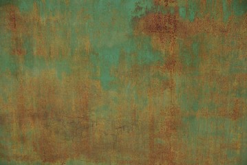 colored iron texture from part of an old green metal wall in brown rust
