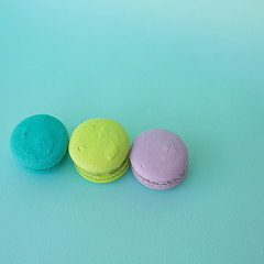 colorful macaroons on a blue square textural background