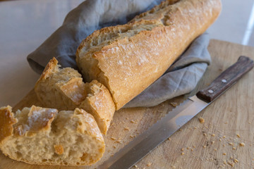 Closeup view of a wooden tray with sliced bread