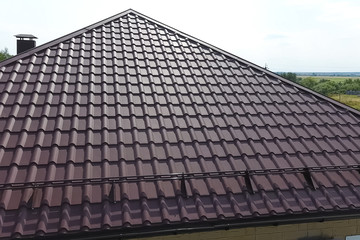 Fototapeta premium Corrugated metal roof and metal roofing. Modern roof made of met
