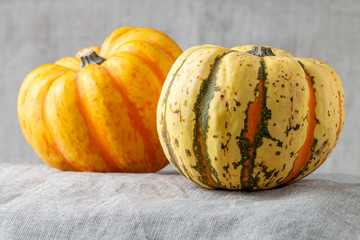 Two gourds on linen tablecloth
