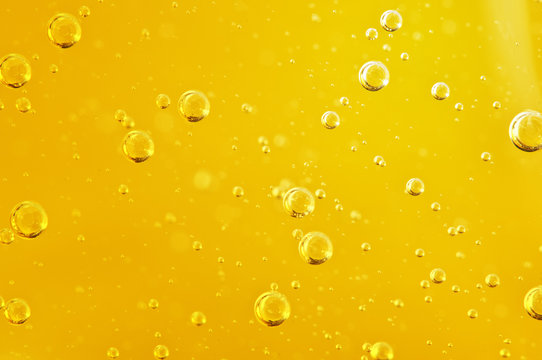 Oil background. Golden liquid with air bubbles on white background  for projects, oil, honey, beer, juice, shampoos.