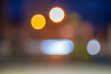 Bright colorful bokeh circles at night. Blurred city lights background.