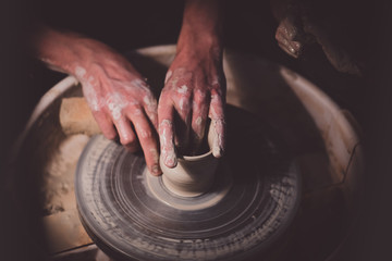 Potter with his daughter make her first clay pot