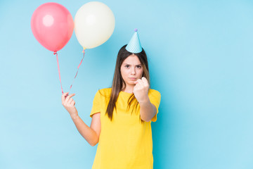Young caucasian woman organizing a birthday isolated