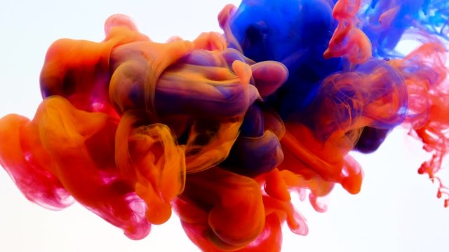 Color paint drops in water , abstract color mix , drop of Ink color mix paint falling on water Colorful ink in water, 4K footage,