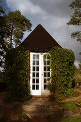 enclosed gazebo in the park twined with girl's grapes