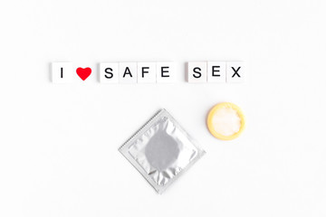 inscription i love safe sex, condom, red heart on a white background