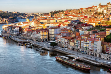 View of the city of Porto from the Eiffel Bridge early in the morning at dawn, small multicolored houses of the Ribeira Quarter
