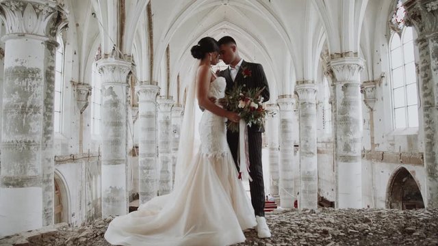bride and groom in a white abandoned monastery