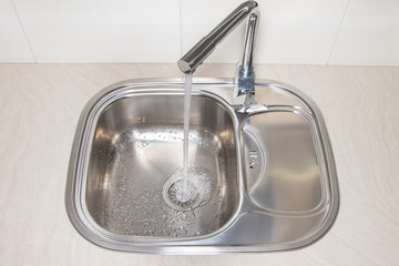 Water flow pouring from the tap.