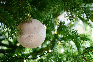 Closeup decorative baubles on the Christmas tree with blurred background in X-mass surroundings