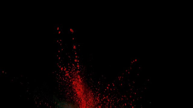 Realistic red powder explosion on black background. Slow motion with acceleration in vertical motion