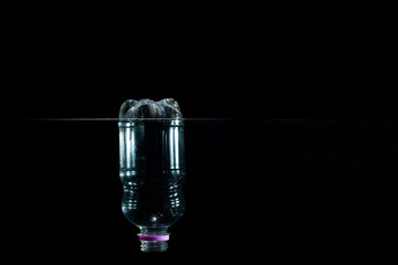  A plastic bottle floating in the sea. Pollution of the environment. Concept of pollution.