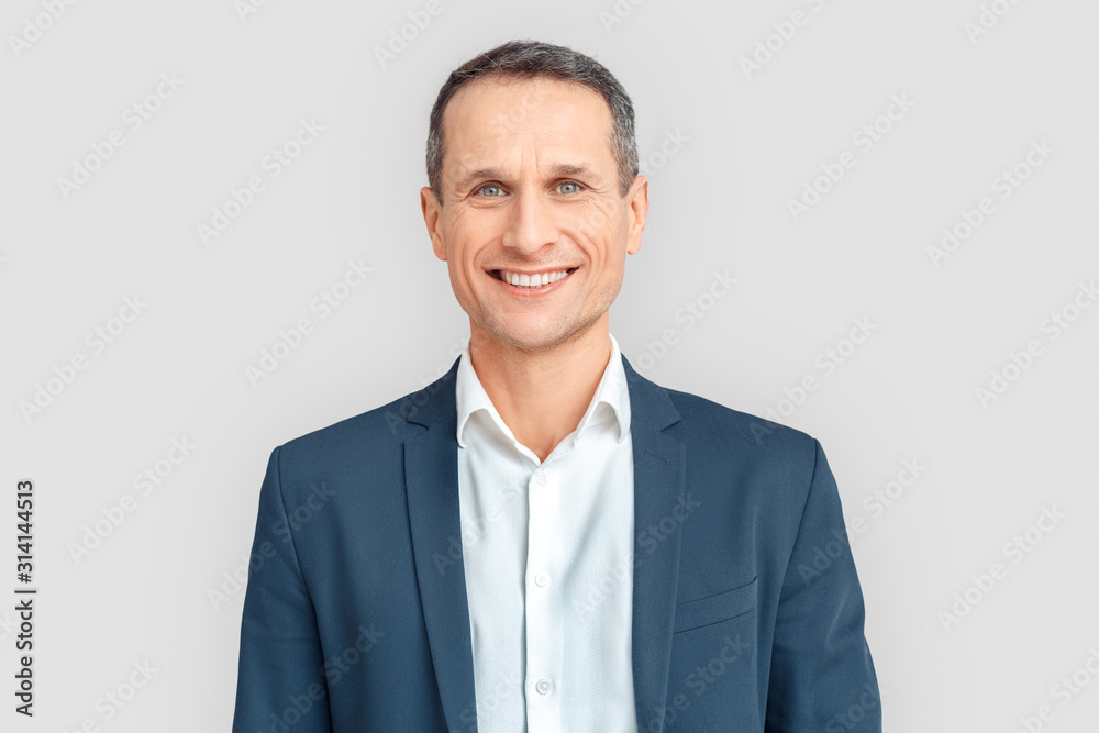 Wall mural Freestyle. Mature businessman standing isolated on white smiling cheerful close-up