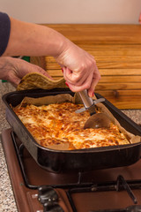 Cutting lasagna with knife