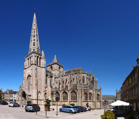 Gothic cathedral with its pointed steeple in the old town of Tréguier in France - obrazy, fototapety, plakaty