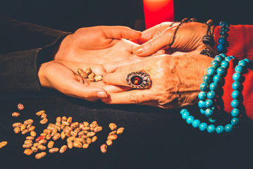 an old woman witch looks into a girl's hands and guesses fate