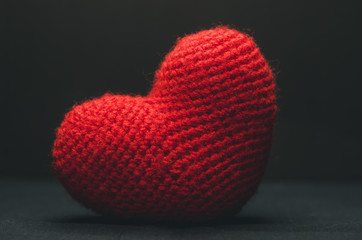 Big red heart on a black background for Valentine's Day. Romance and love concept