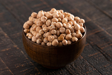 Bowl of Dry Chickpeas on a Rustic Wooden Table