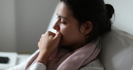 Pensive candid nervous anxious young woman biting nails, authentic real life lady feeling anxiety