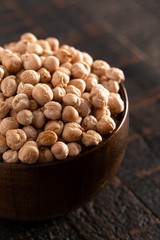 Bowl of Dry Chickpeas on a Rustic Wooden Table
