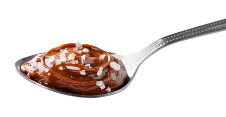 Salted caramel in spoon isolated on white