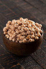 Bowl of Dry Chickpeas on a Rustic Wooden Table