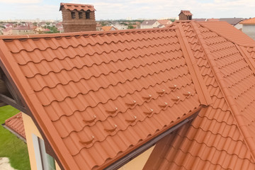 House with a new roof made of orange metal. View from above. Cor