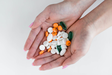 Woman holding group of prescription pills in hands