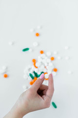 Woman holding prescription pills in hands