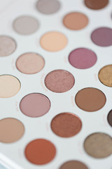 Neutral eyeshadow makeup palette on marble background