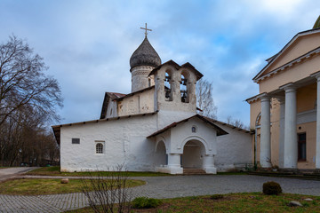 Fototapeta na wymiar Ancient white-stone Orthodox church with a wooden tiled dome and a double bell tower