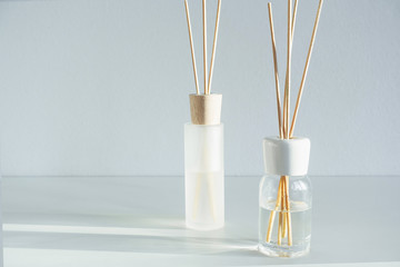 Reed diffusers on table. Air fresheners for home isolated on white background. Aromatic sticks with...