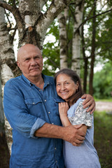 cute older man and woman in birch grove
