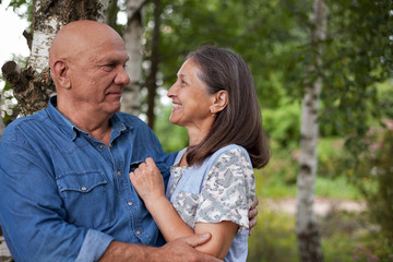 older man and woman in birch grove