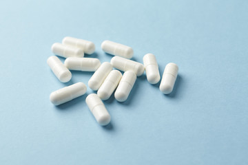 Leucine amino acid. Fitness supplement on bright paper background. Close up. Copy space. 