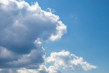 Naklejka na ściany i meble Big white clouds with blue sky in the background.