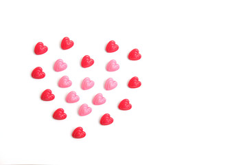 Red and pink heart beads shape - top view / flat lay with white background
