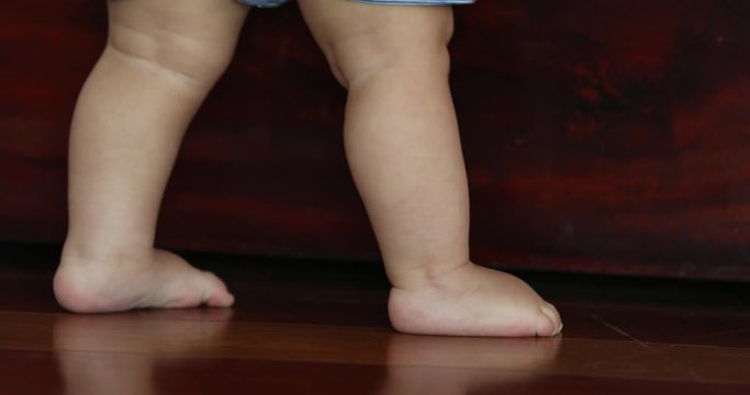 Small baby feet and toes tiptoeing. Child toddler tiptoes closeup
