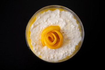 Sweet tapioca pudding with coconut milk and fresh mango flowers