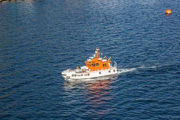 Picture of pilot cutter taken from a cruise ship during daytime