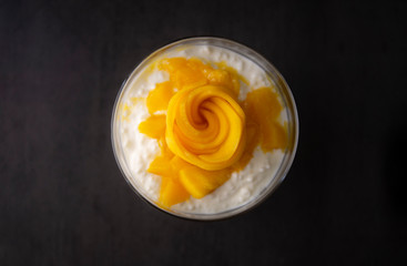 Sweet tapioca pudding with coconut milk and fresh mango flowers