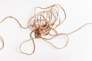 Tangled thread isolated on white illustrating concepts of complex problem, obstacle, stress